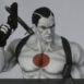 Bloodshot statue pose holding right hand pistol in air in a closeup overhead shot